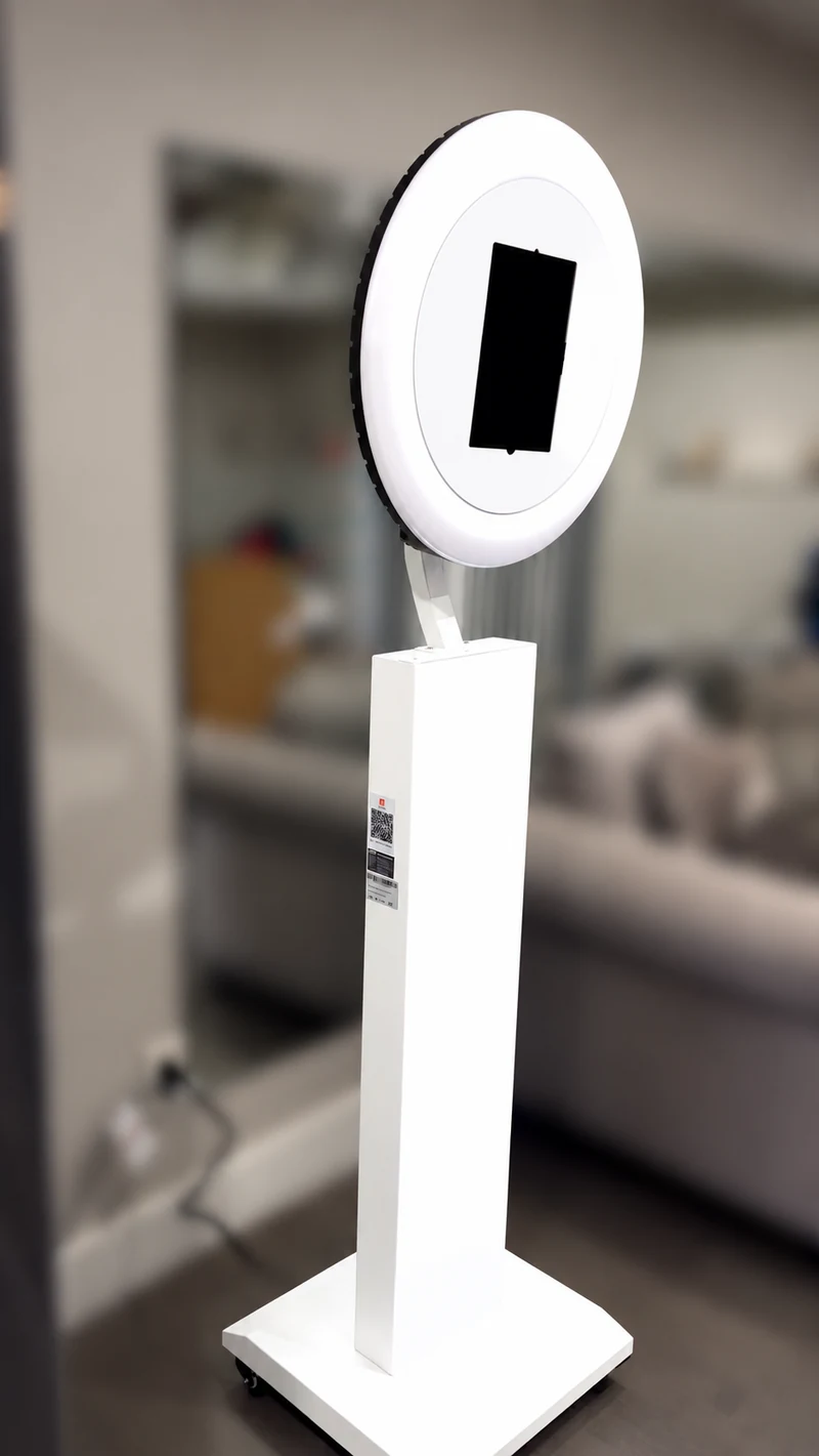 Our actual white digital photo booth with circular light and square pedestal base, during our practice setup